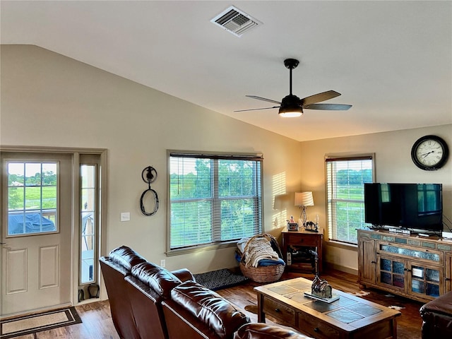 living room featuring ceiling fan, vaulted ceiling, and dark wood-type flooring