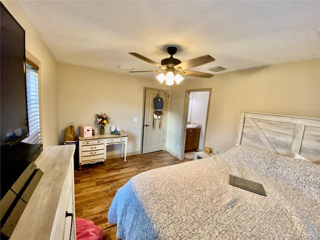 bedroom featuring ensuite bathroom, ceiling fan, and dark hardwood / wood-style flooring