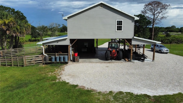 rear view of house with a yard and a carport