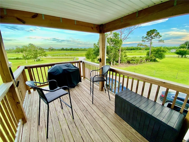 wooden terrace featuring a lawn