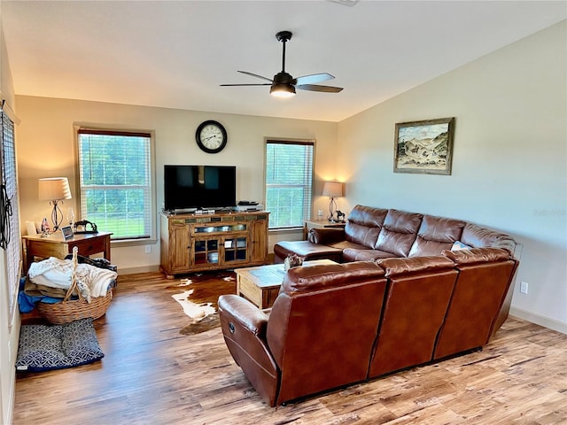 living room with lofted ceiling, light hardwood / wood-style floors, and ceiling fan