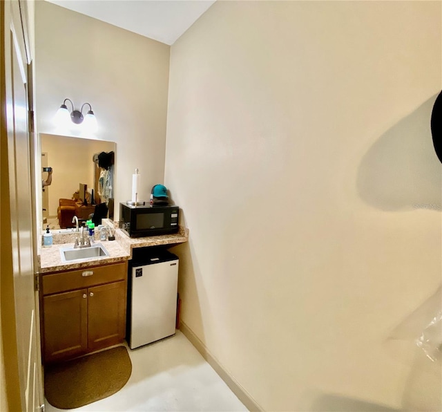 bathroom featuring concrete floors and large vanity