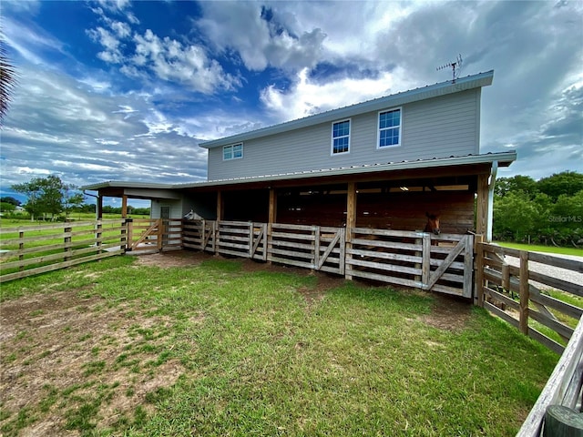 back of property featuring a yard