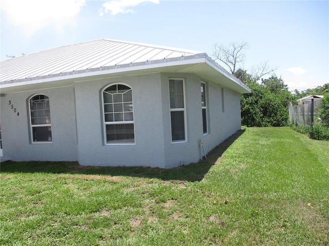 view of property exterior featuring a lawn