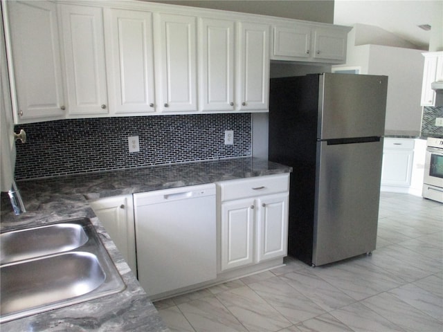 kitchen with light tile floors, tasteful backsplash, white appliances, white cabinets, and sink