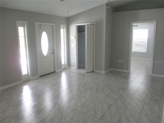 tiled entrance foyer featuring a healthy amount of sunlight and lofted ceiling