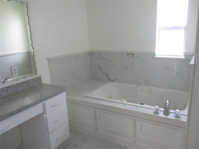 bathroom with tile floors, vanity, and a bathtub