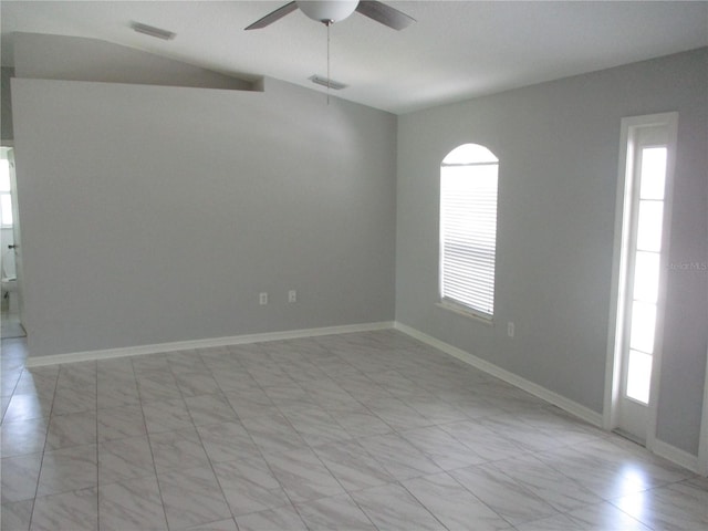 tiled spare room with a healthy amount of sunlight and ceiling fan