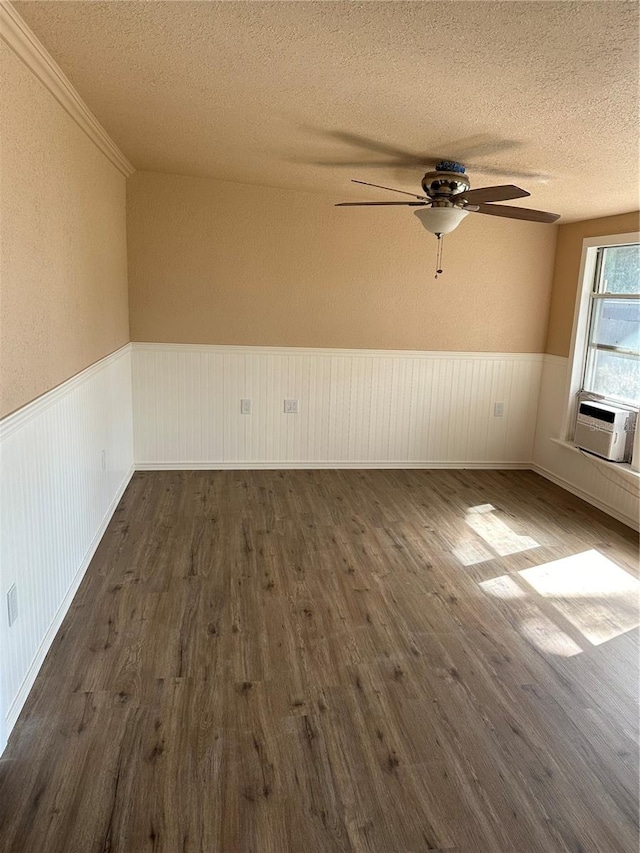 spare room with ceiling fan, dark wood-type flooring, a textured ceiling, and cooling unit