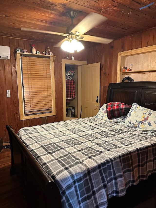 bedroom with ceiling fan, hardwood / wood-style flooring, wood ceiling, and wooden walls