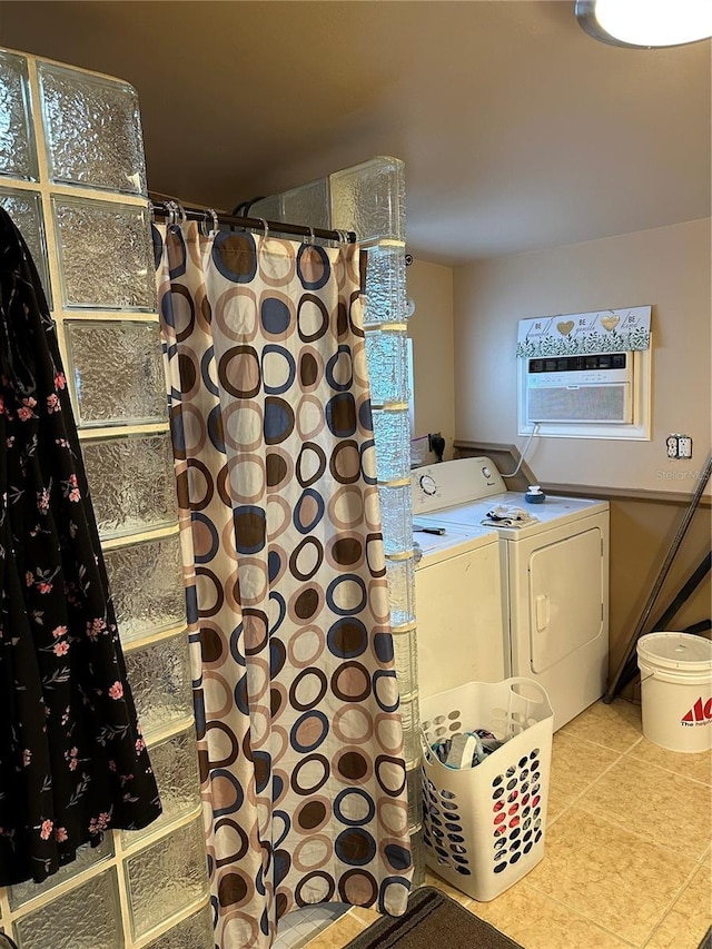 washroom featuring washing machine and dryer and light tile patterned floors