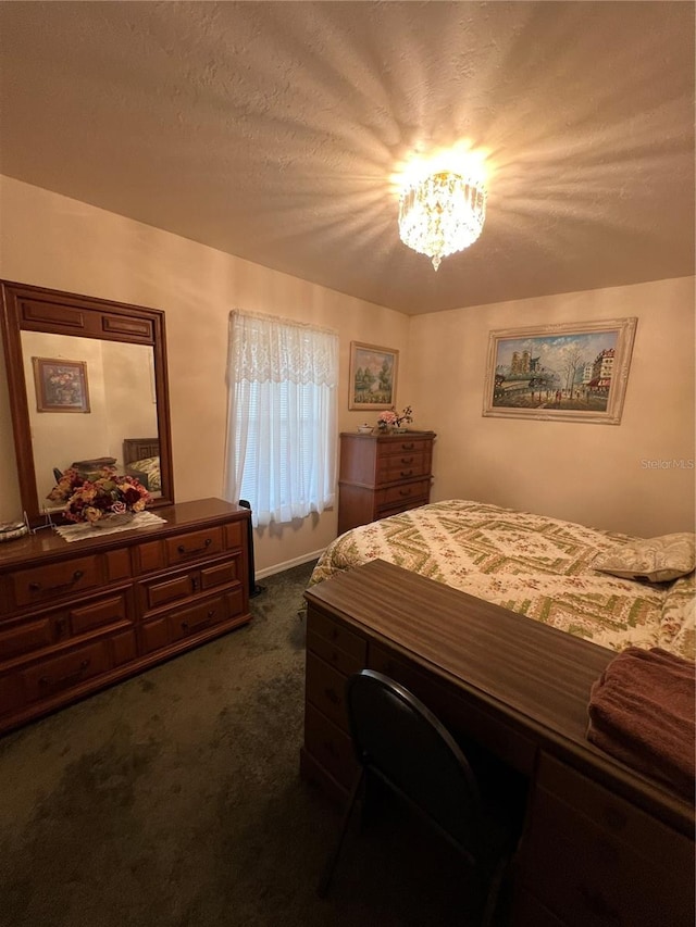 bedroom with a chandelier, a textured ceiling, and dark colored carpet