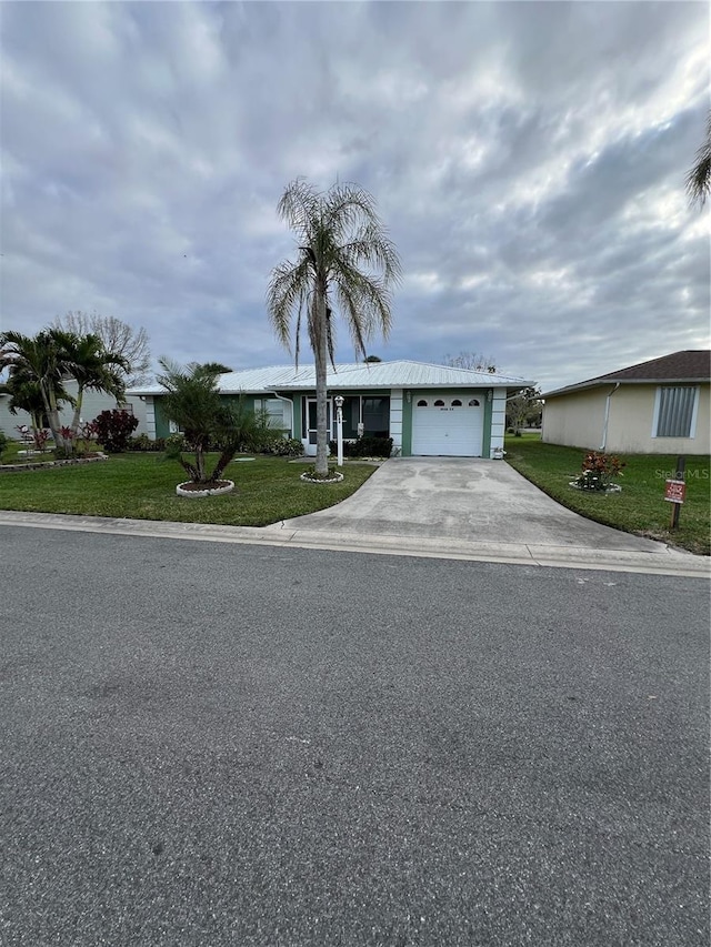 ranch-style home with a garage and a front lawn