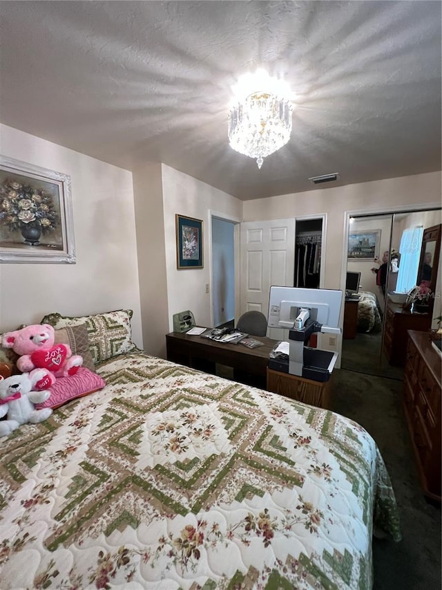 bedroom with an inviting chandelier and a textured ceiling