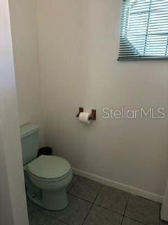 bathroom featuring toilet and tile flooring