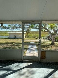 doorway to outside with a healthy amount of sunlight and concrete floors