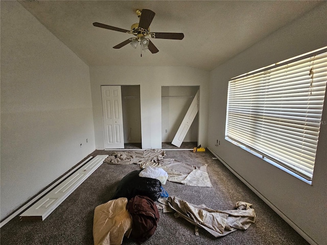 unfurnished bedroom with carpet, ceiling fan, vaulted ceiling, and multiple windows