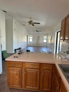 kitchen featuring sink, ceiling fan, and tile flooring