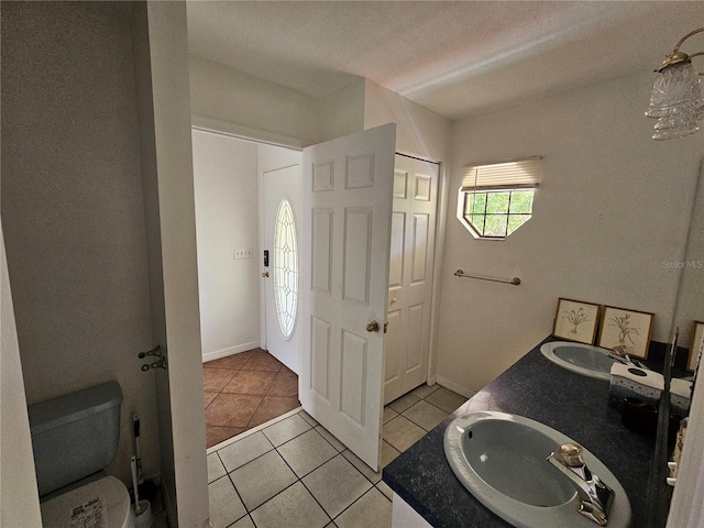 bathroom with double sink vanity and tile floors