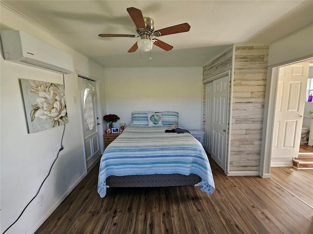 bedroom featuring ceiling fan, dark hardwood / wood-style floors, and a wall mounted AC