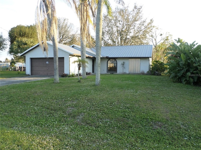 ranch-style house featuring a garage and a front yard