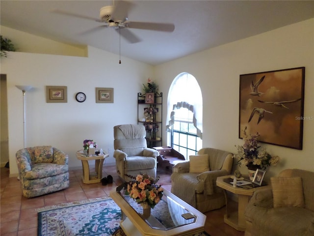 tiled living room with ceiling fan, a healthy amount of sunlight, and vaulted ceiling