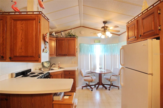 kitchen with ceiling fan, sink, vaulted ceiling, stove, and white refrigerator