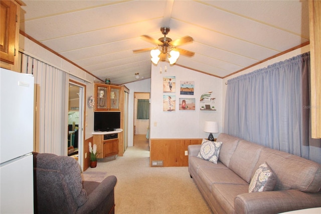 living room with vaulted ceiling, light colored carpet, and ceiling fan