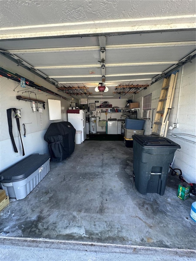 garage with a garage door opener, white fridge, and refrigerator