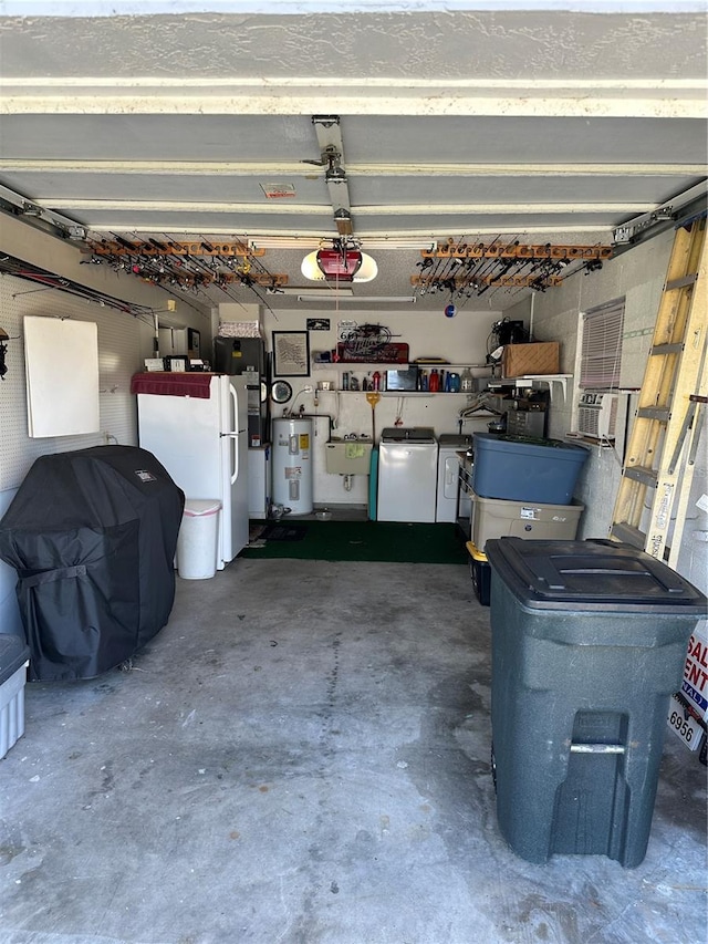 garage featuring white fridge, sink, washer and clothes dryer, electric water heater, and a garage door opener