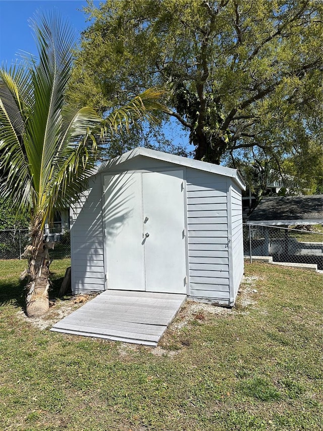 view of shed / structure with a lawn