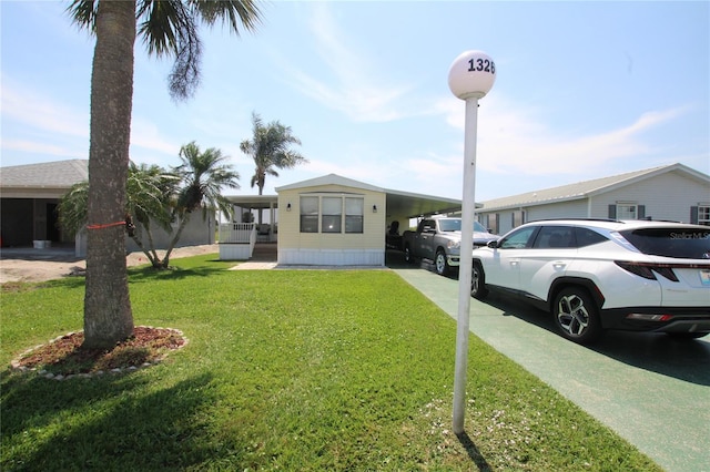 view of front of property with a front yard and a carport