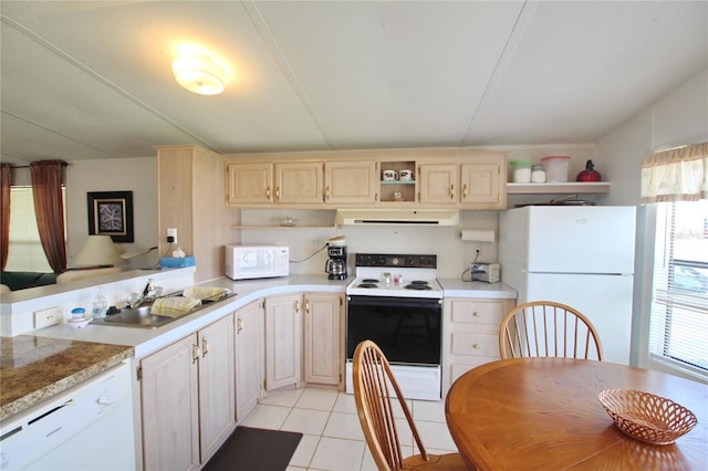 kitchen featuring white appliances, sink, exhaust hood, and a wealth of natural light