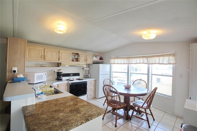 kitchen featuring sink, white appliances, vaulted ceiling, and light tile floors