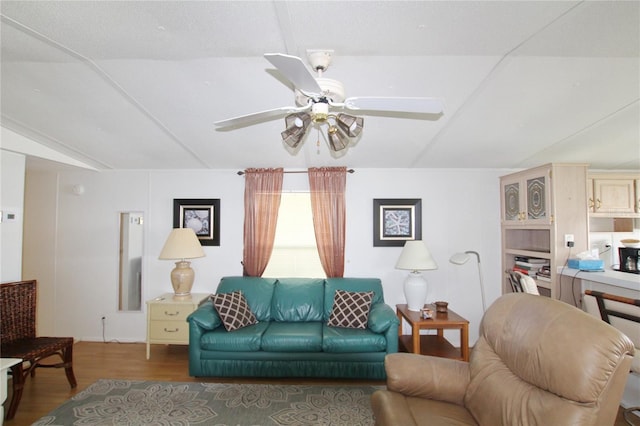 living room featuring ceiling fan, lofted ceiling, and dark hardwood / wood-style floors