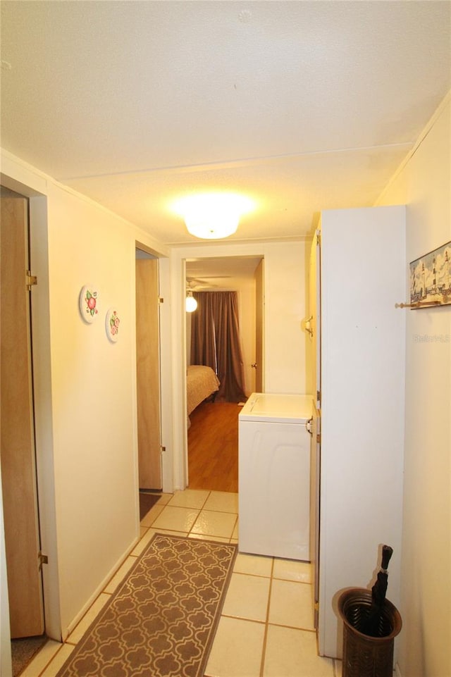 laundry room featuring washer / dryer and light tile flooring