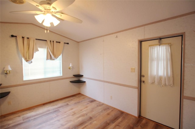 spare room featuring lofted ceiling, light hardwood / wood-style floors, and ceiling fan