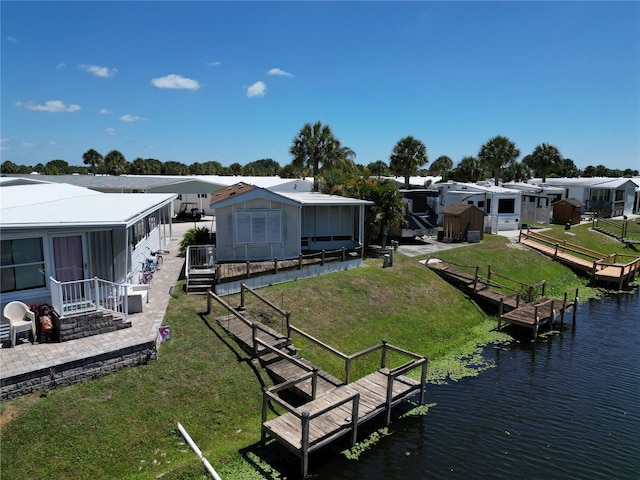 view of dock featuring a water view and a lawn