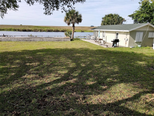 view of yard with a patio and a water view