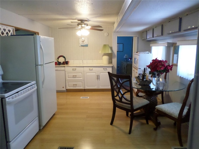 kitchen featuring white cabinetry, light hardwood / wood-style floors, ceiling fan, and white appliances