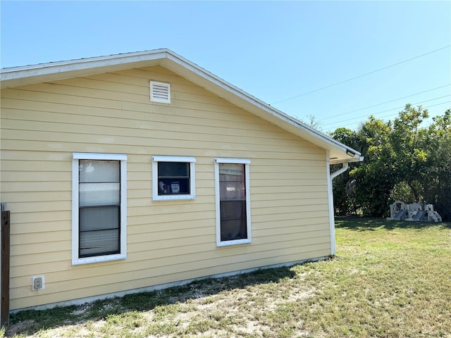 view of home's exterior with a yard