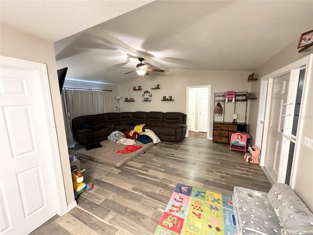 living room featuring hardwood / wood-style floors, ceiling fan, and lofted ceiling