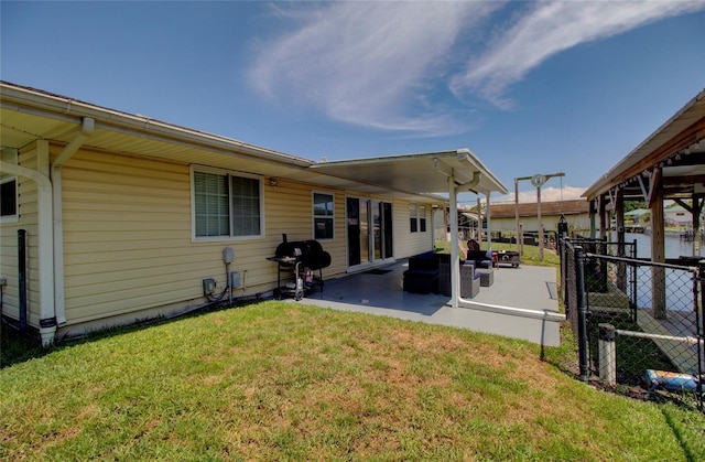 back of property featuring a patio and a lawn