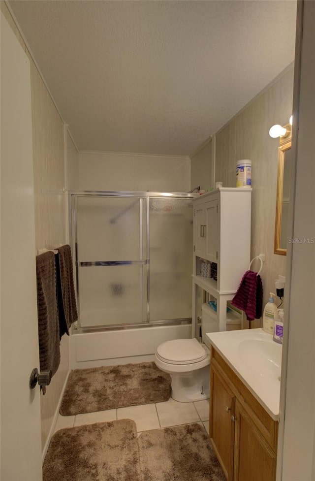 full bathroom with toilet, tile patterned floors, vanity, and shower / bath combination with glass door