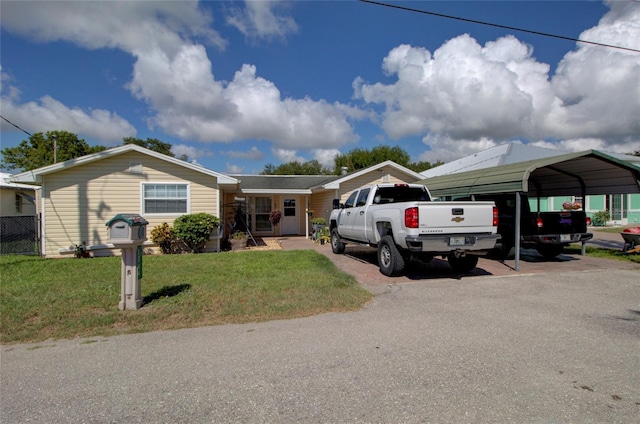 view of front of house featuring a carport and a front lawn