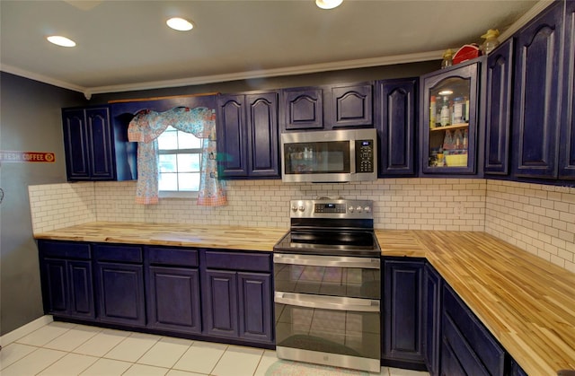 kitchen with butcher block counters, crown molding, tasteful backsplash, and stainless steel appliances