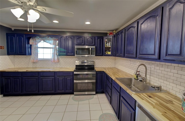 kitchen featuring stainless steel appliances, sink, and butcher block countertops