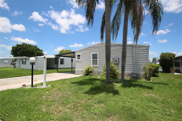 view of front facade with a carport and a front yard