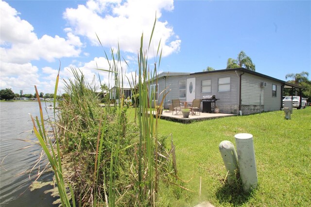 view of yard with a patio and a water view