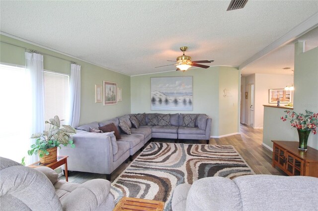 living room with a textured ceiling, ceiling fan, and hardwood / wood-style floors